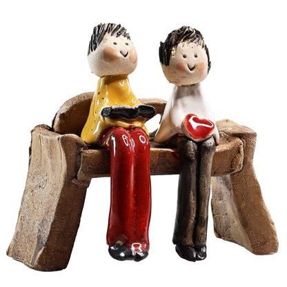 Handmade Couple on Bench. Man with Book, Lady with Heart